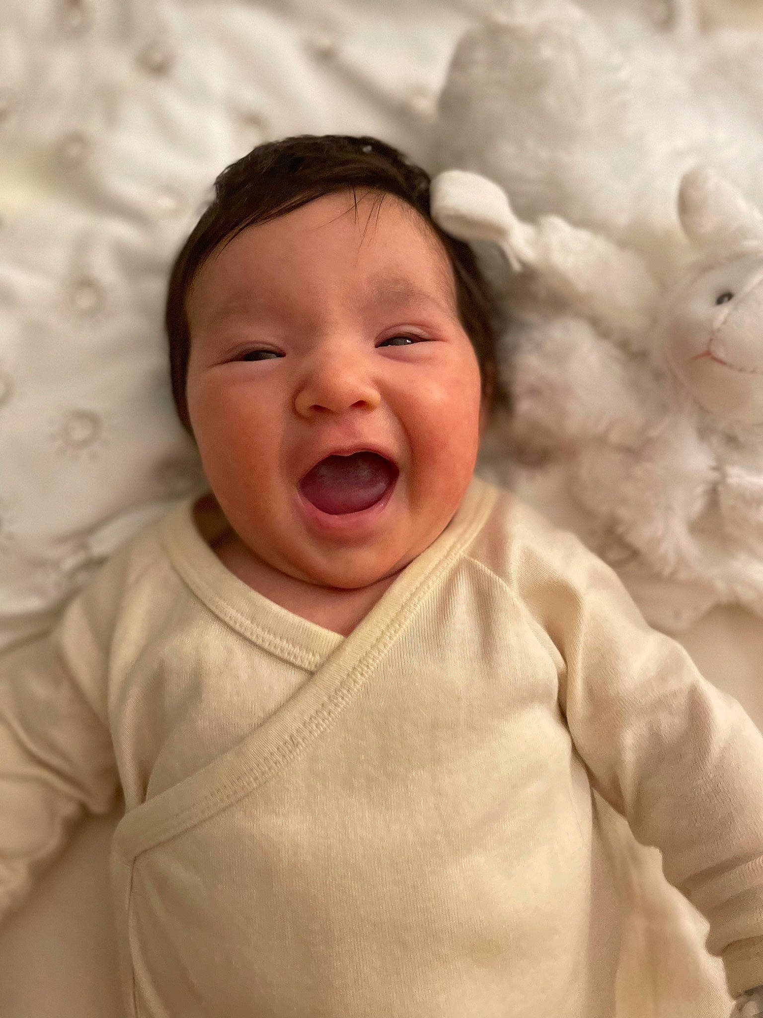 Sienna is registered to the contest to win money with this photo: baby, baby_toddler_clothing, cheek, child, chin, comfort, facial_expression, finger, fun, gesture, happy, headwear, linens, lip, mouth, nose, person, pink, skin, sleeve