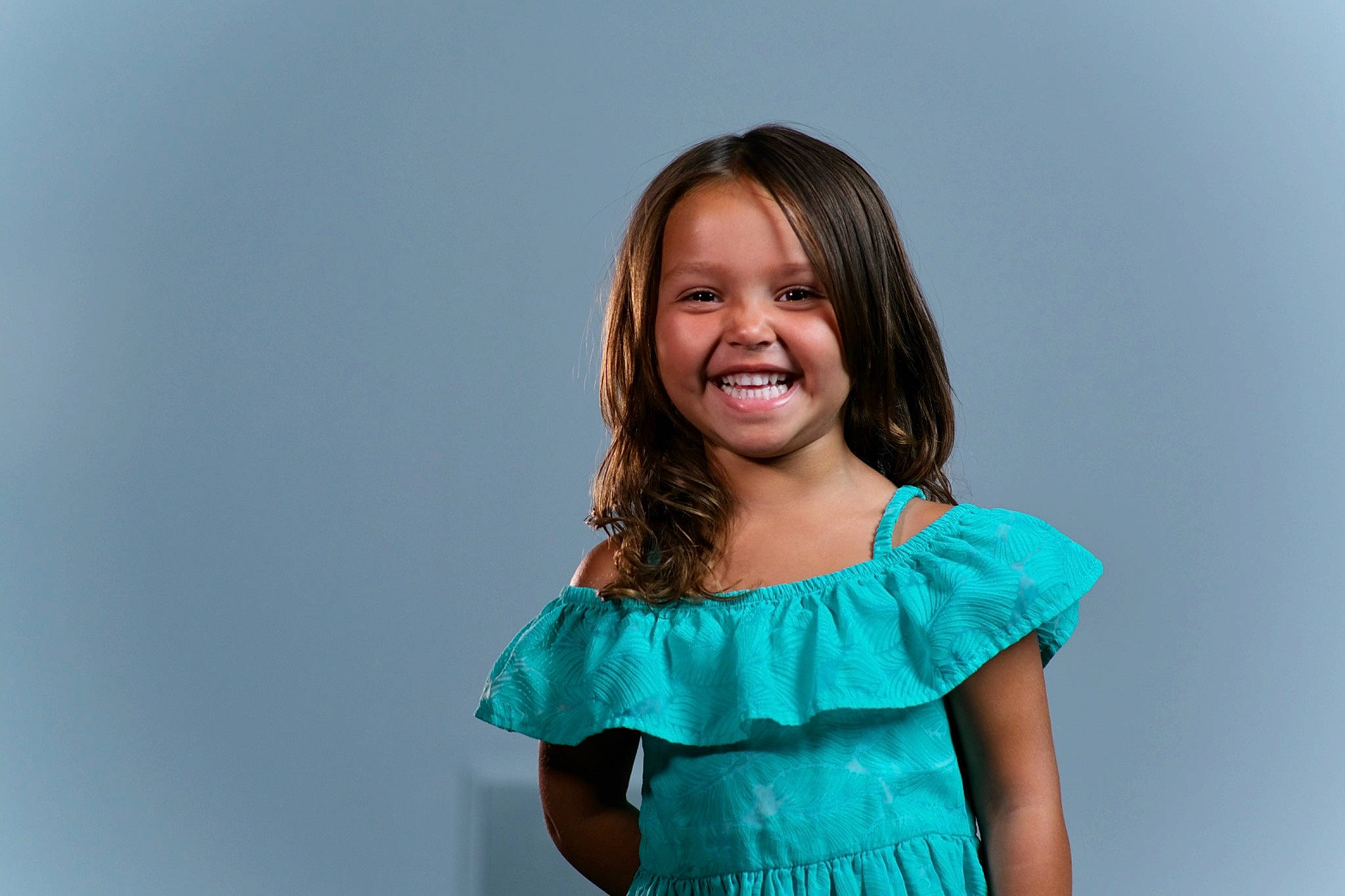 Wrigley is registered to the contest to win money with this photo: arm, brown_hair, day_dress, dress, electric_blue, event, fashion_design, flash_photography, formal_wear, gesture, happy, jewellery, joy, leisure, long_hair, magenta, neck, person, sleeve, smile