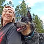 Ladybug is registered to the contest to win money with this photo: woman, dog, outdoor, trees, sky, smiling, cap, pet, nature, happy, canine, portrait, collar, daylight, friendship, animal, casual, person, tongue_out, forest