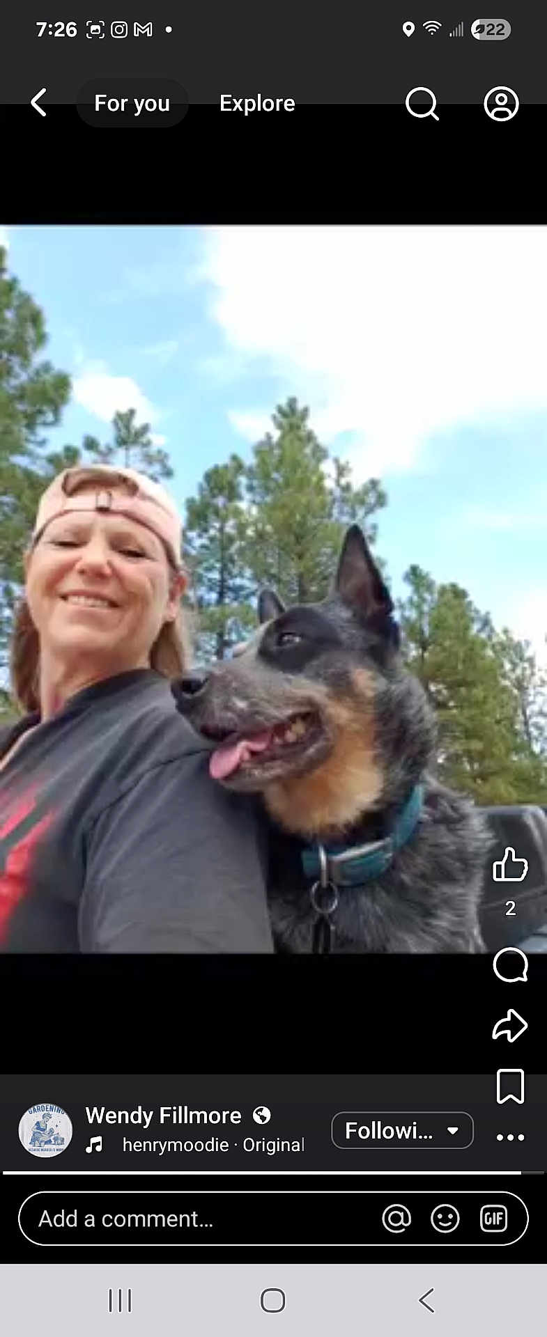 Ladybug is registered to the contest to win money with this photo: woman, dog, outdoor, trees, sky, smiling, cap, pet, nature, happy, canine, portrait, collar, daylight, friendship, animal, casual, person, tongue_out, forest