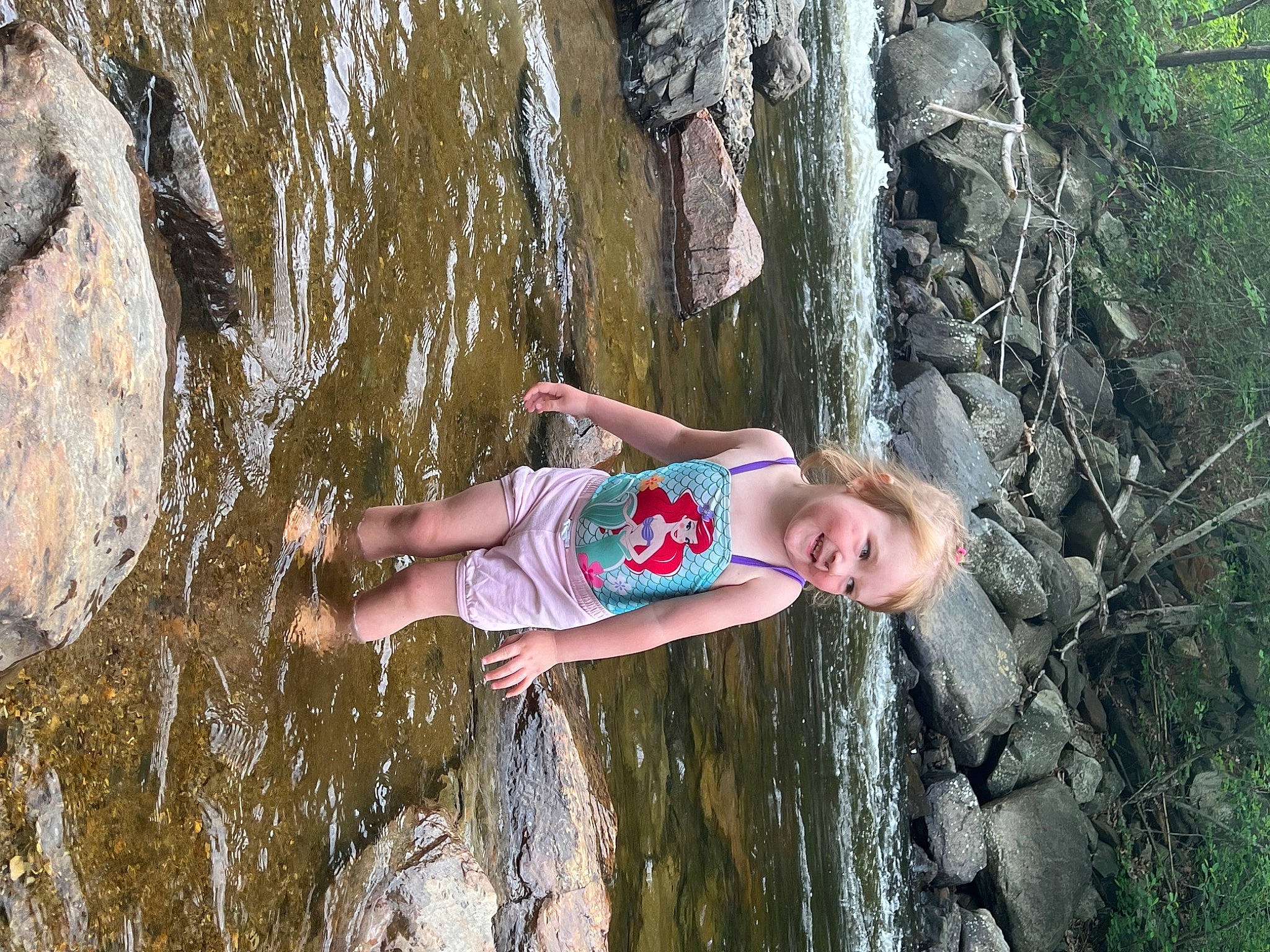 Ashlyn joined the competition — help win amazing prizes! adventure, bedrock, body_of_water, formation, fun, joy, leisure, mammal, natural_environment, organism, outdoor_recreation, people_in_nature, person, plant, recreation, shorts, sport_climbing, trunk, vertebrate, water