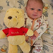 Charles joined the competition — help win amazing prizes! baby, infant, plush_toy, winnie_the_pooh, tigger, blanket, onesie, cute, smiling, lying_down, soft_toy, child, cozy, patterned_clothing, sleepwear, comfort, indoor, portrait, toy, face