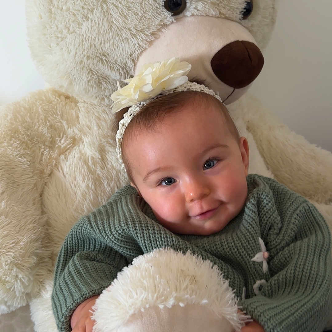 Soline Soyez participe au concours pour gagner de l'argent avec cette photo : adorable, baby, child, comfort, cuddly, cute, flower_headband, green_sweater, happy, headband, hugging, indoor, infant, plush_toy, portrait, smiling, soft_texture, teddy_bear, warm, young_child