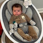 Keam joined the competition — help win amazing prizes! baby, baby_boy, baby_rocker, baby_seat, baby_toy, brown_pajamas, child, clothing, comfort, cute, expression, face, floor, home, indoor, infant, mittens, modern, pacifier, wooden_floor