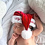 Keam is registered to the contest to win money with this photo: baby, sleeping, santa_hat, christmas, holiday, infant, soft, white, blanket, cute, peaceful, child, festive, red, pom_pom, portrait, indoors, cozy, newborn, resting