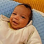 Martin a rejoint le concours — aidez-le/la à gagner de superbes lots ! baby, smiling, infant, face, white_clothing, pillow, blue_pillow, yellow_cushion, cozy, indoors, cute, child, portrait, resting, comfortable, soft_texture, young_child, happy, closeup, warm_colors