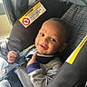 Maeast joined the competition — help win amazing prizes! baby, car_seat, smile, infant, child, straps, clothing, seatbelt, face, person, cute, happy, indoors, head, young_child, sitting, portrait, light, fabric, seat
