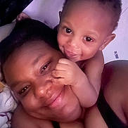 Maeast is registered to the contest to win money with this photo: baby, adult, smile, face, closeup, affection, playful, skin, person, child, love, happy, indoors, together, bond, portrait, family, head, expression, cuddle