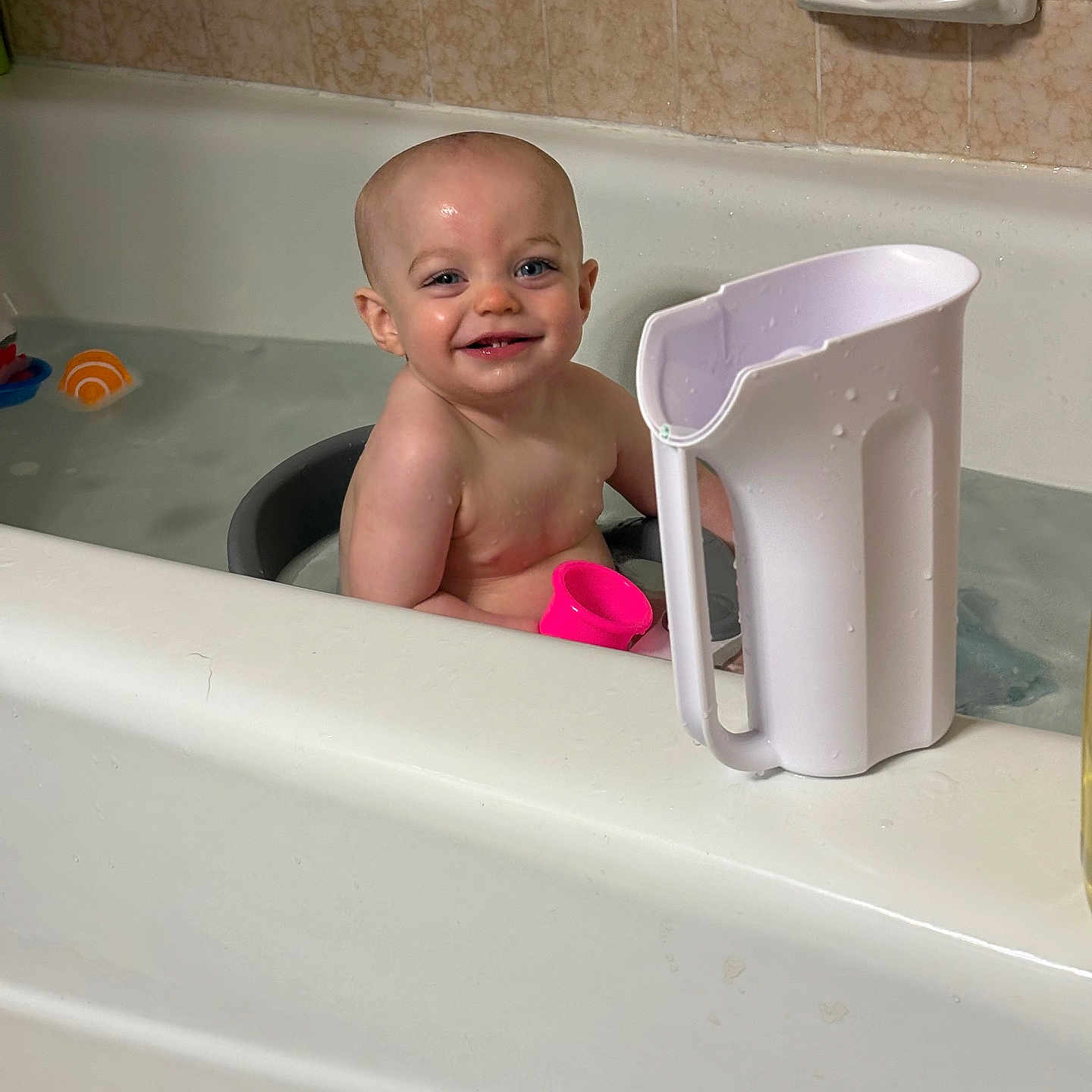 Rivers joined the competition — help win amazing prizes! baby, bathtub, bathroom, child, smile, toy, water, tile, pitcher, pink, white, skin, head, face, happy, sitting, bath, clean, play, indoor