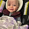 Rivers is registered to the contest to win money with this photo: baby, smiling, car_seat, blanket, infant, child, face, head_support, clothing, safety, seat_belt, happy, cute, indoors, person, infant_girl_or_boy, closeup, baby_boy, baby_girl, newborn