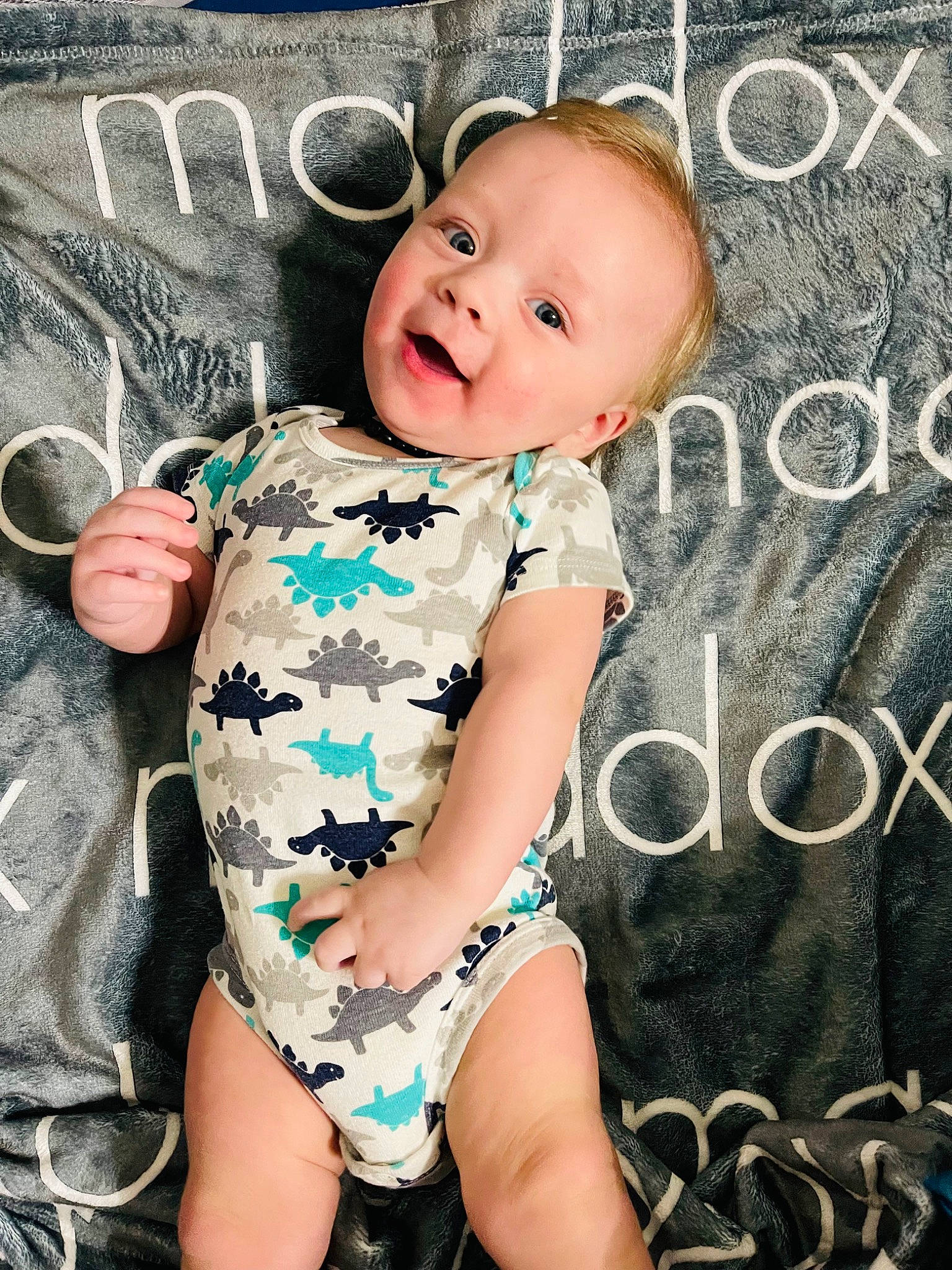Maddox is registered to the contest to win money with this photo: baby, baby_toddler_clothing, child, cool, facial_expression, finger, flash_photography, font, happy, human, neck, organ, person, photograph, pink, skin, sleeve, smile, textile, thigh