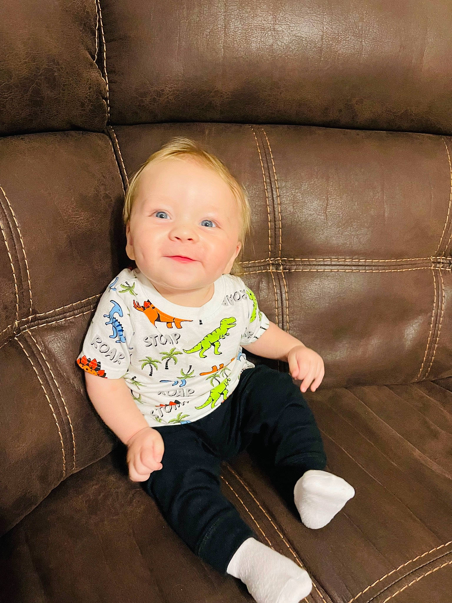 Maddox is registered to the contest to win money with this photo: baby, baby_toddler_clothing, cheek, child, comfort, face, flash_photography, floor, flooring, foot, hair, happy, hardwood, pattern, person, sitting, sleeve, sock, tints_and_shades, toddler