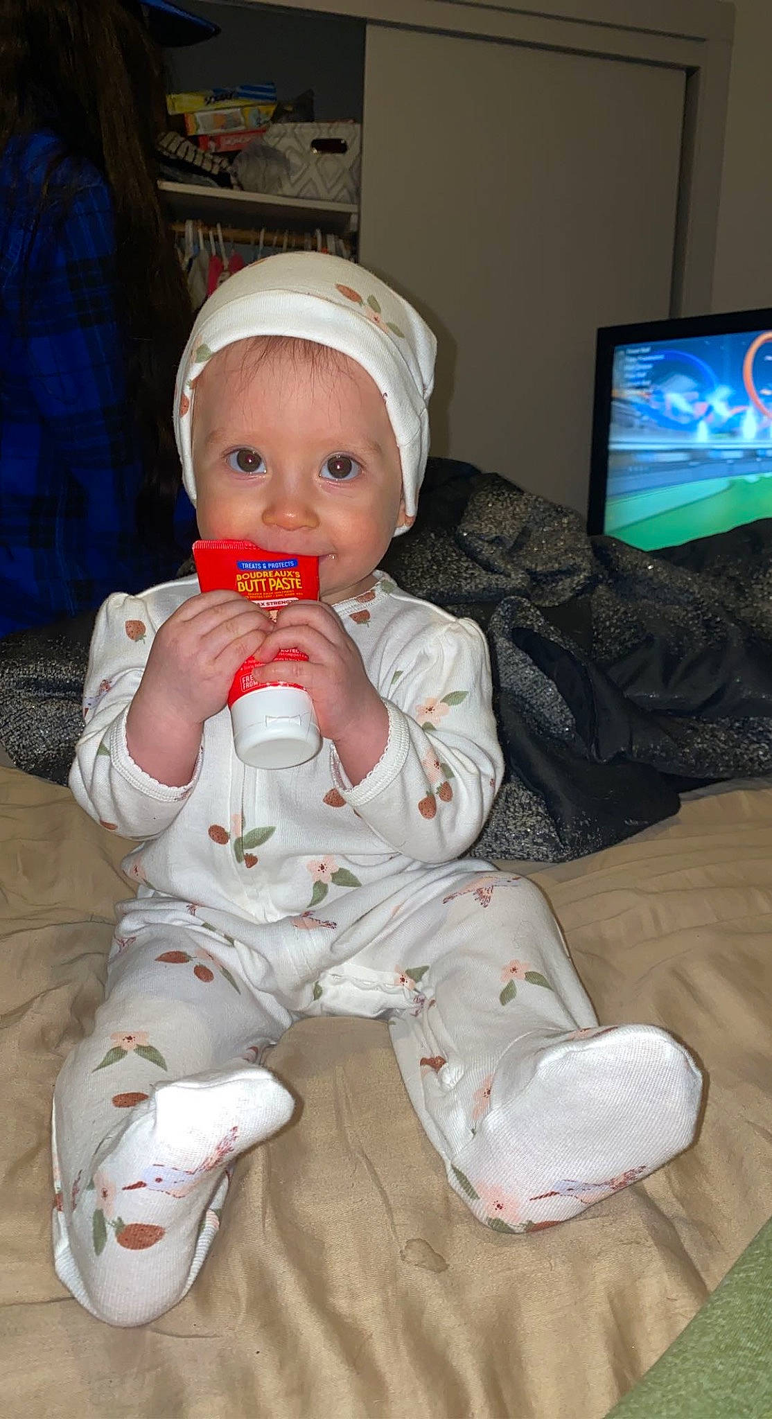 Isabella Caudillo joined the competition — help win amazing prizes! baby, baby_toddler_clothing, cap, carmine, cheek, child, comfort, display_device, drinkware, facial_expression, foot, fun, head, mouth, nose, person, personal_protective_equipment, room, sitting, television