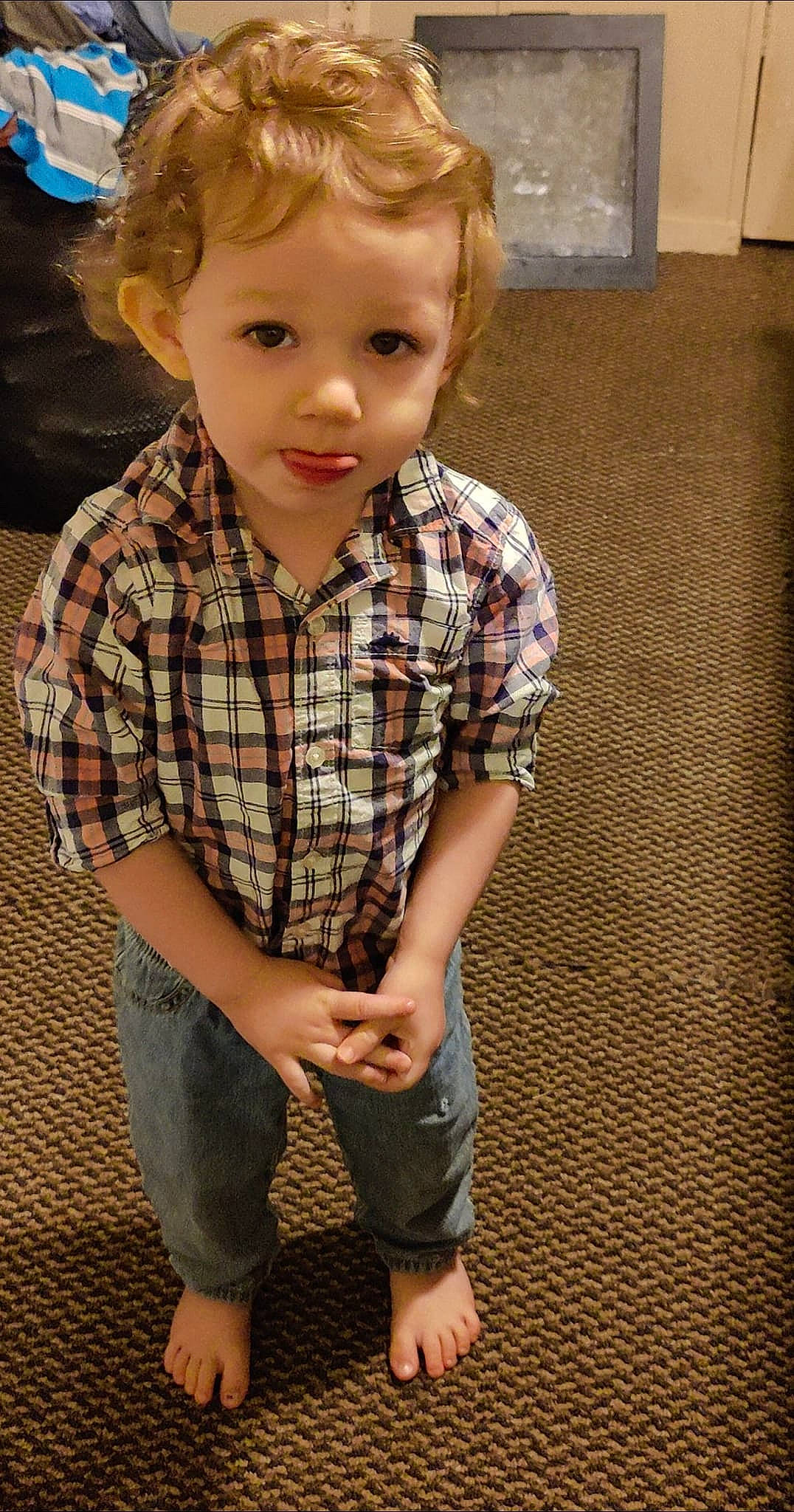 Lincoln is registered to the contest to win money with this photo: cheek, chin, eye, face, flooring, fun, hair, hairstyle, happy, head, human, nose, person, plaid, sleeve, smile, standing, t_shirt, tartan, toddler