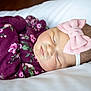 Josie is registered to the contest to win money with this photo: baby, sleeping, infant, headband, bow, purple_clothing, floral_pattern, soft_surface, peaceful, cute, child, newborn, resting, portrait, closeup, face, skin, sleep, cozy, comfort