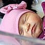 Josie joined the competition — help win amazing prizes! baby, sleeping, pink_hat, bow, floral_outfit, closeup, face, infant, peaceful, soft_lighting, newborn, portrait, skin, headwear, cute, resting, indoor, child, clothing, adorable
