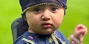 Haya joined the competition — help win amazing prizes! child, toddler, face, headscarf, blue_clothing, embroidery, outdoor, green_background, curious, portrait, person, young_child, cute, fashion, nature, closeup, eyes, expression, traditional_clothing, baby