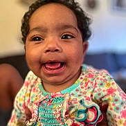 Mellissia joined the competition — help win amazing prizes! baby, child, smiling, curly_hair, floral_dress, colorful_clothing, happy, portrait, indoor, person, cute, closeup, infant, ruffles, playful, young_child, skin, face, eyes, mouth