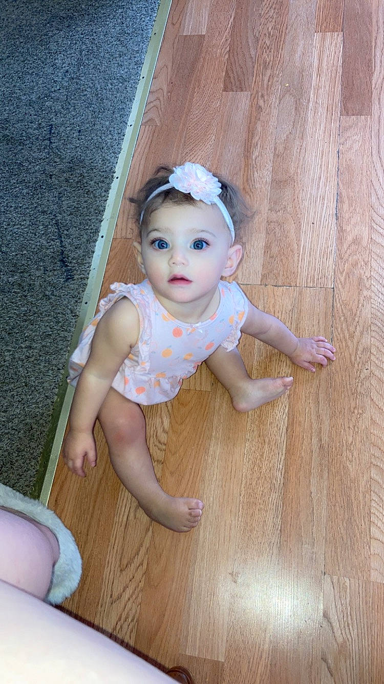 Arielle joined the competition — help win amazing prizes! baby, baby_toddler_clothing, child, eye, fawn, floor, flooring, foot, fun, happy, hardwood, headband, headpiece, human_leg, iris, pattern, person, sitting, surprise, thigh