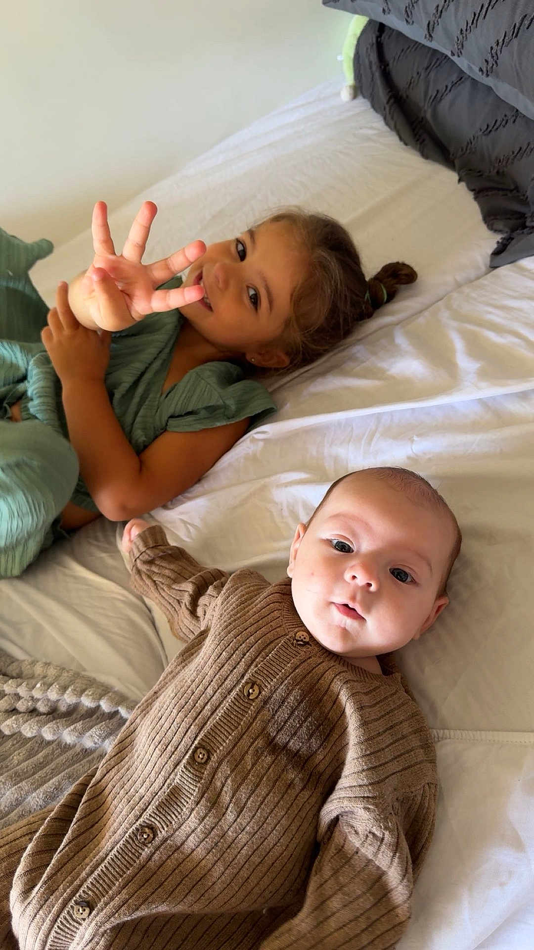 Zayyan a rejoint le concours — aidez-le/la à gagner de superbes lots ! child, baby, bed, blanket, brown_clothing, curly_hair, cute, expression, face, finger_gesture, girl, infant, knitwear, laying_down, light_skin, looking_at_camera, person, playful, smiling, soft_lighting