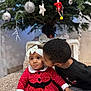 baby, bow, candid, celebration, child, christmas_tree, cute, decorations, family, festive, happy, headband, holiday, indoors, kiss, love, ornaments, red_dress, siblings, smiling
