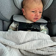 Ajdin joined the competition — help win amazing prizes! newborn, baby, car_seat, blanket, infant, child, face, head, clothing, seatbelt, straps, fabric, portrait, indoor, person, expression, wrapped, cute, small, resting