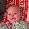 Sadie joined the competition — help win amazing prizes! apparel, baby, blanket, cartoon_characters, child, cozy, cute, face, happy, head, indoors, infant, lying_down, onesie, pattern, portrait, red, sleepwear, smiling, white