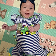 Sadie joined the competition — help win amazing prizes! accessory, animal_print, baby, bow, bright, child, colorful, cute, fun, happy, headband, indoors, infant, lying_down, person, play_mat, portrait, smiling, striped_clothing, young