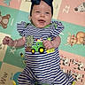 accessory, animal_print, baby, bow, bright, child, colorful, cute, fun, happy, headband, indoors, infant, lying_down, person, play_mat, portrait, smiling, striped_clothing, young