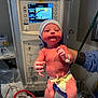 Mia joined the competition — help win amazing prizes! newborn, baby, hospital, medical_equipment, infant, diaper, gloved_hands, umbilical_clamp, monitor, baby_cap, hospital_id_band, stethoscope, medical_setting, person, healthcare, newborn_care, baby_weight_display, sterile_environment, baby_temperature_monitor, holding