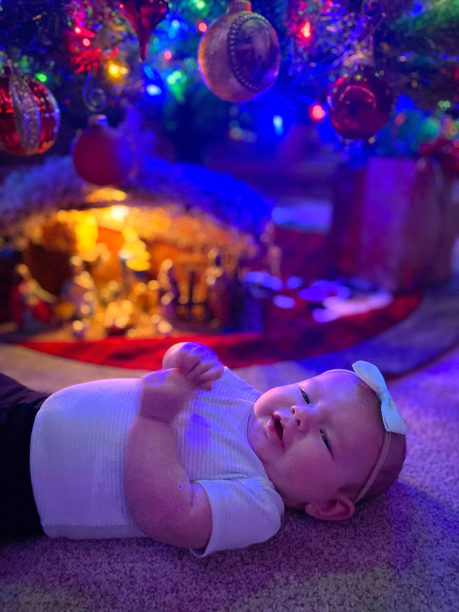 Madalynn is registered to the contest to win money with this photo: baby, blue, christmas_decoration, christmas_ornament, christmas_tree, electric_blue, entertainment, event, flooring, fun, leisure, light, lighting, magenta, ornament, person, plant, purple, red, toddler