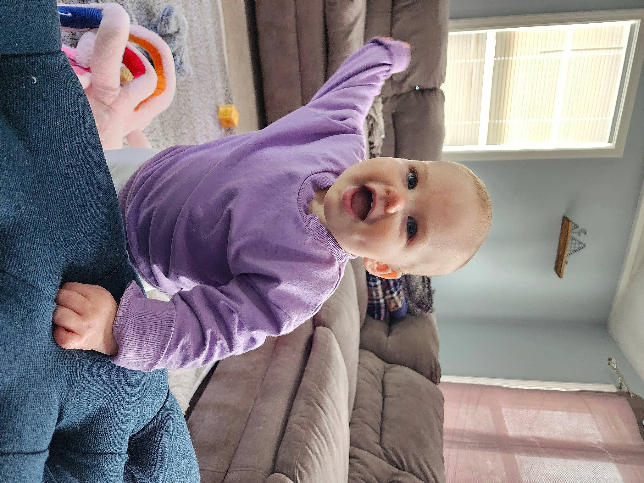 Lily is registered to the contest to win money with this photo: arm, baby, baby_toddler_clothing, child, comfort, event, eyewear, fun, gesture, happy, joint, magenta, person, pink, purple, sitting, sleeve, smile, suit, toddler