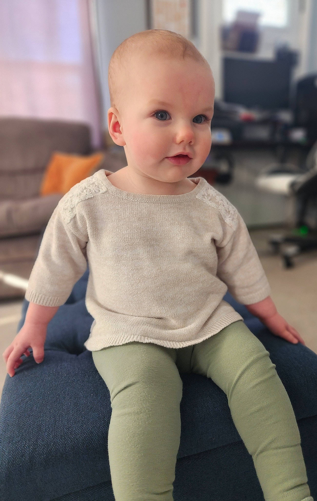 Lily is registered to the contest to win money with this photo: baby, baby_toddler_clothing, cheek, child, comfort, elbow, face, flooring, human_body, human_leg, joint, knee, lip, person, sitting, sleeve, sportswear, t_shirt, thigh, toddler