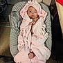 Estelle is registered to the contest to win money with this photo: baby, infant, newborn, hooded_towel, pink_towel, towel, baby_seat, bouncer, portrait, look_at_camera, cute, indoors, kitchen, floor_tiles, dog, pet, cabinet, blanket, feet, hand