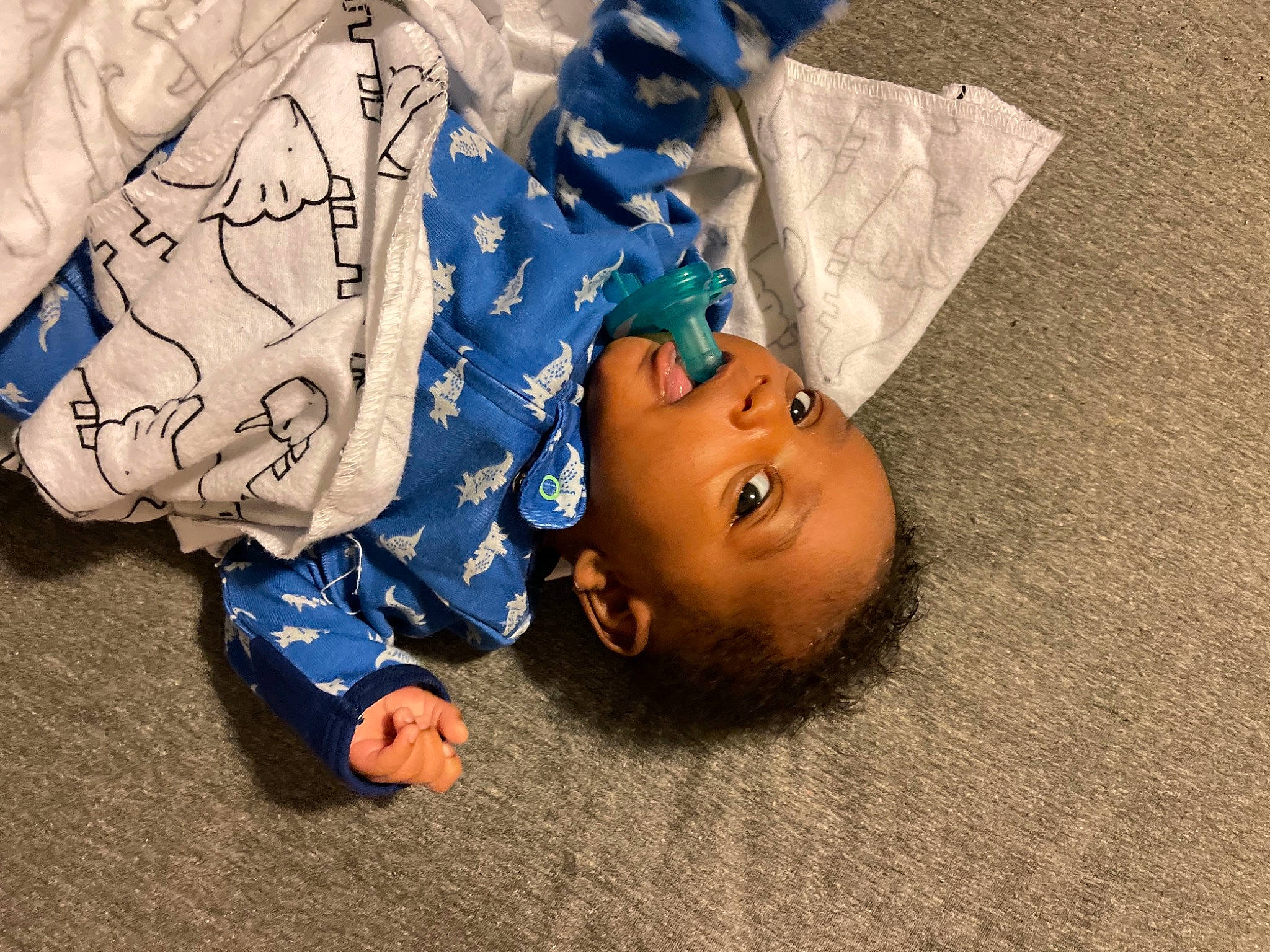 Aayden is registered to the contest to win money with this photo: baby, child, electric_blue, fashion_accessory, flooring, fun, grass, happy, headgear, human_body, illustration, linens, nap, pattern, person, sitting, sleep, toddler, tree