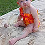 Paisley is registered to the contest to win money with this photo: baby, child, sandbox, sand, swimsuit, orange, pink, pout, outdoor, grass, trees, nature, summer, cute, funny_face, barefoot, skin, one_person, sitting, daylight