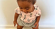 Nazarielle is registered to the contest to win money with this photo: baby, casual_clothing, child, curly_hair, cute, fashion, floral_top, gray_shorts, hair_buns, happy, indoor, person, playful, portrait, smiling, standing, toddler, white_shoes, wooden_floor, young_child