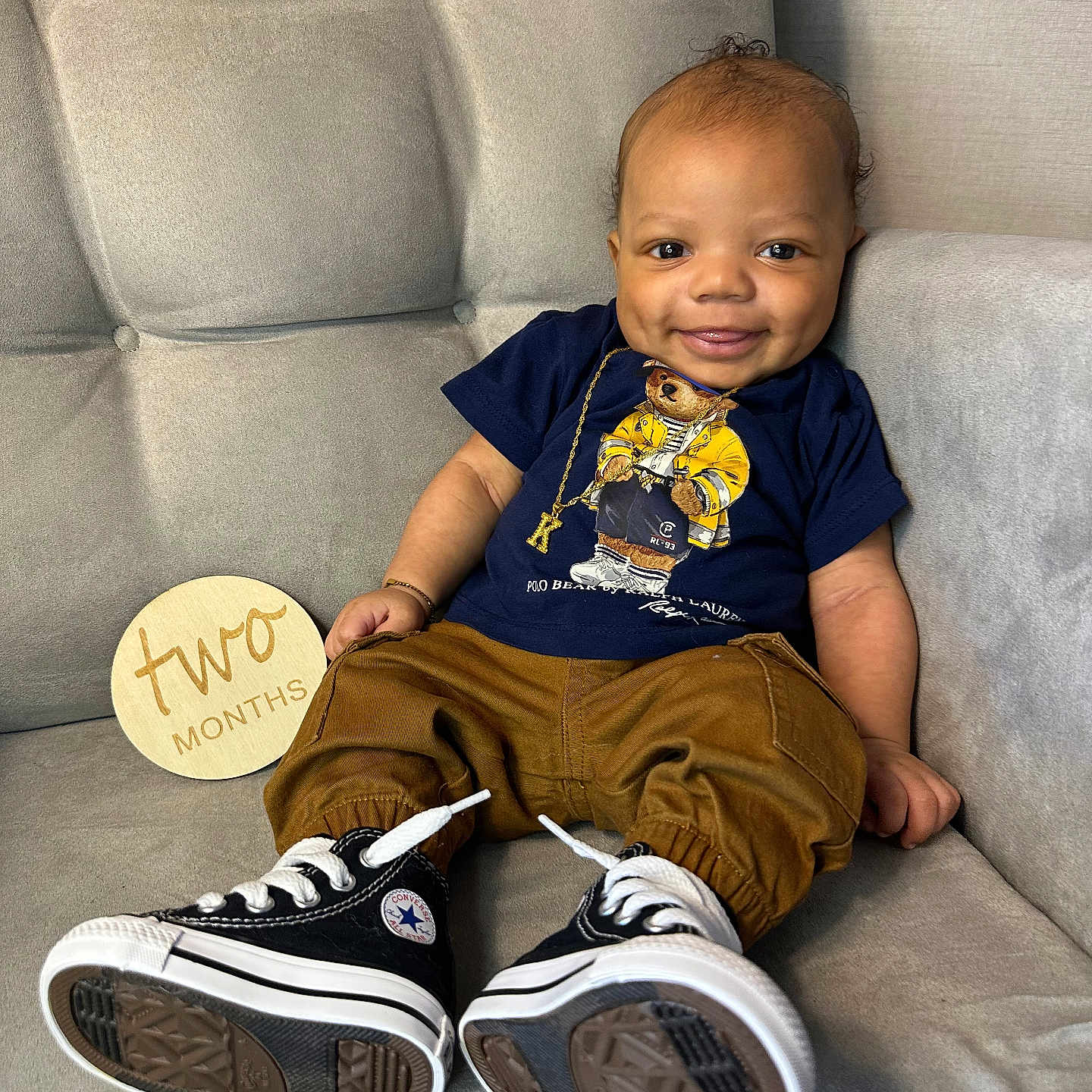 Khamari is registered to the contest to win money with this photo: baby, boy, child, clothing, couch, face, footwear, furniture, head, homedecor, jeans, male, pants, person, photography, portrait, shoe, sitting, sneaker, t_shirt