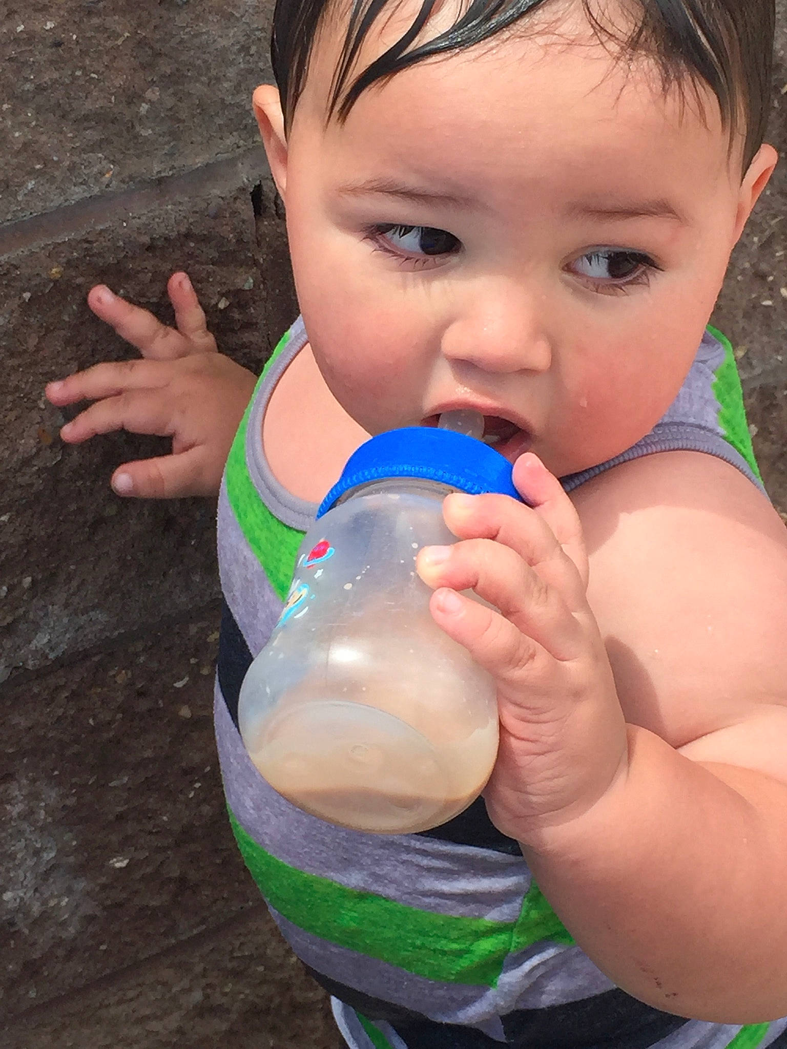 Thadd is registered to the contest to win money with this photo: arm, azure, baby_bottle, bottle, chest, drinking, drinkware, finger, gesture, hand, happy, human_body, joint, leisure, nail, people_in_nature, person, plastic_bottle, thumb, toddler