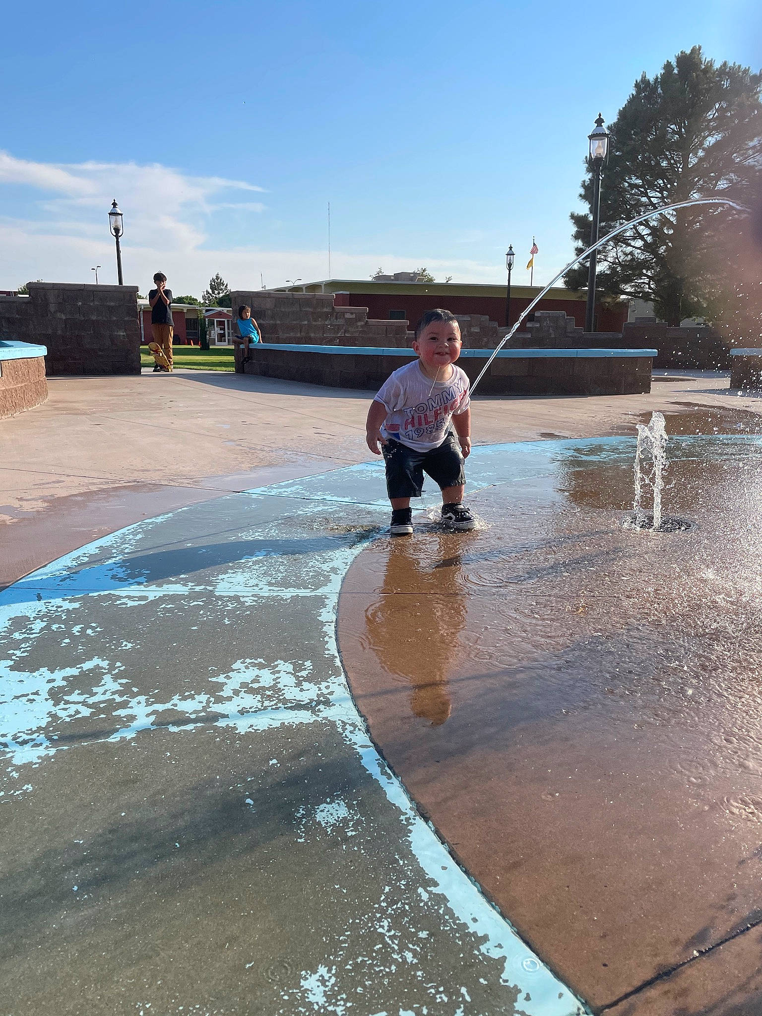 Thadd joined the competition — help win amazing prizes! asphalt, city, concrete, flooring, fountain, freezing, fun, joy, leisure, person, recreation, reflection, road, road_surface, sidewalk, sky, street_light, tree, water, water_feature