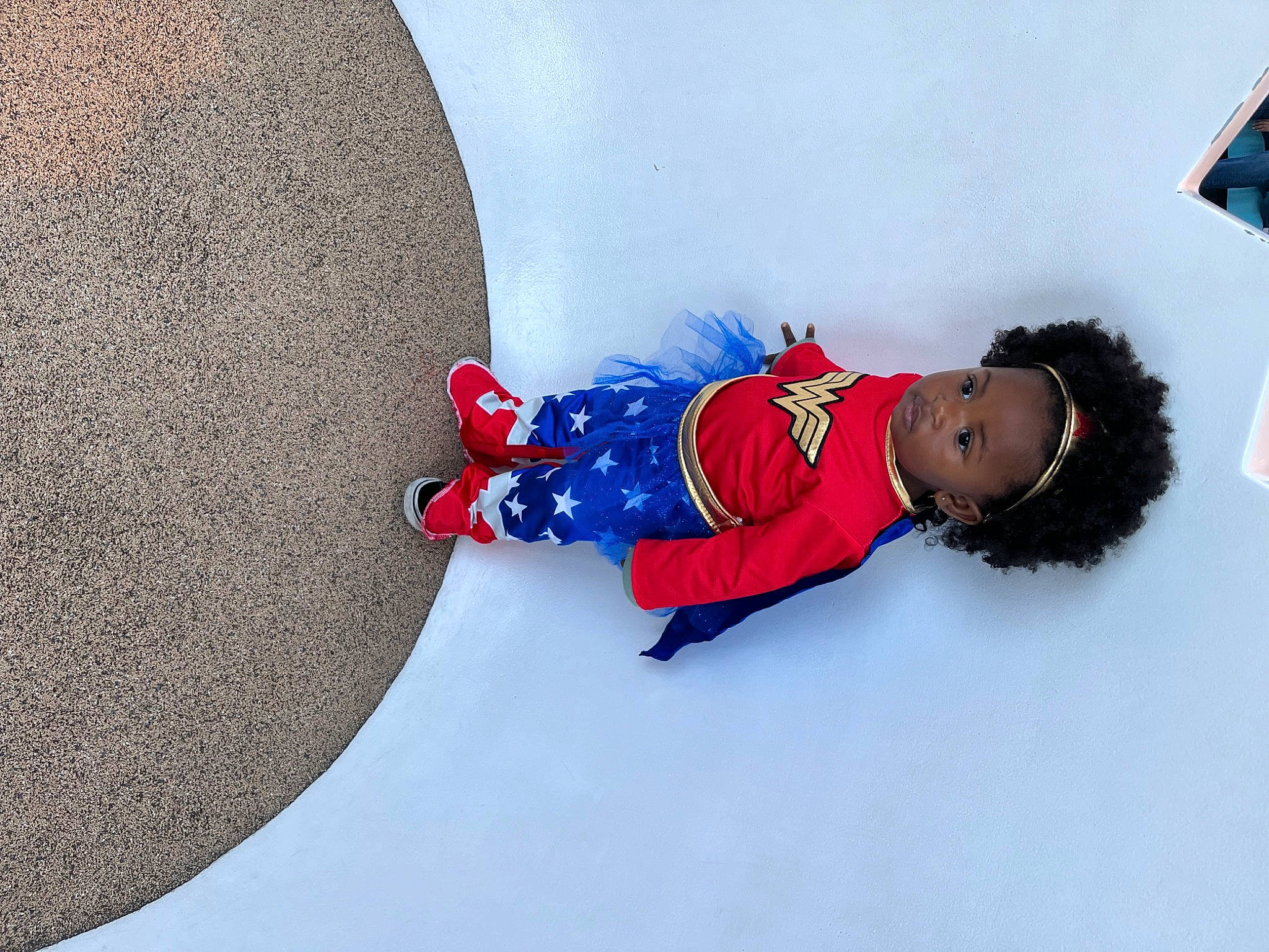 Marcia is registered to the contest to win money with this photo: baby_toddler_clothing, carmine, child, circle, comfort, concrete, electric_blue, freezing, fun, happy, leisure, people_in_nature, person, playing_in_the_snow, sitting, slope, snow, toddler, travel, winter