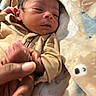 newborn, baby, infant, child, portrait, sleepy, face, hand, foot, tan_outfit, zipper, blanket, plush_blanket, cozy, indoors, close_up, lying_down, family, caregiving, soft_lighting
