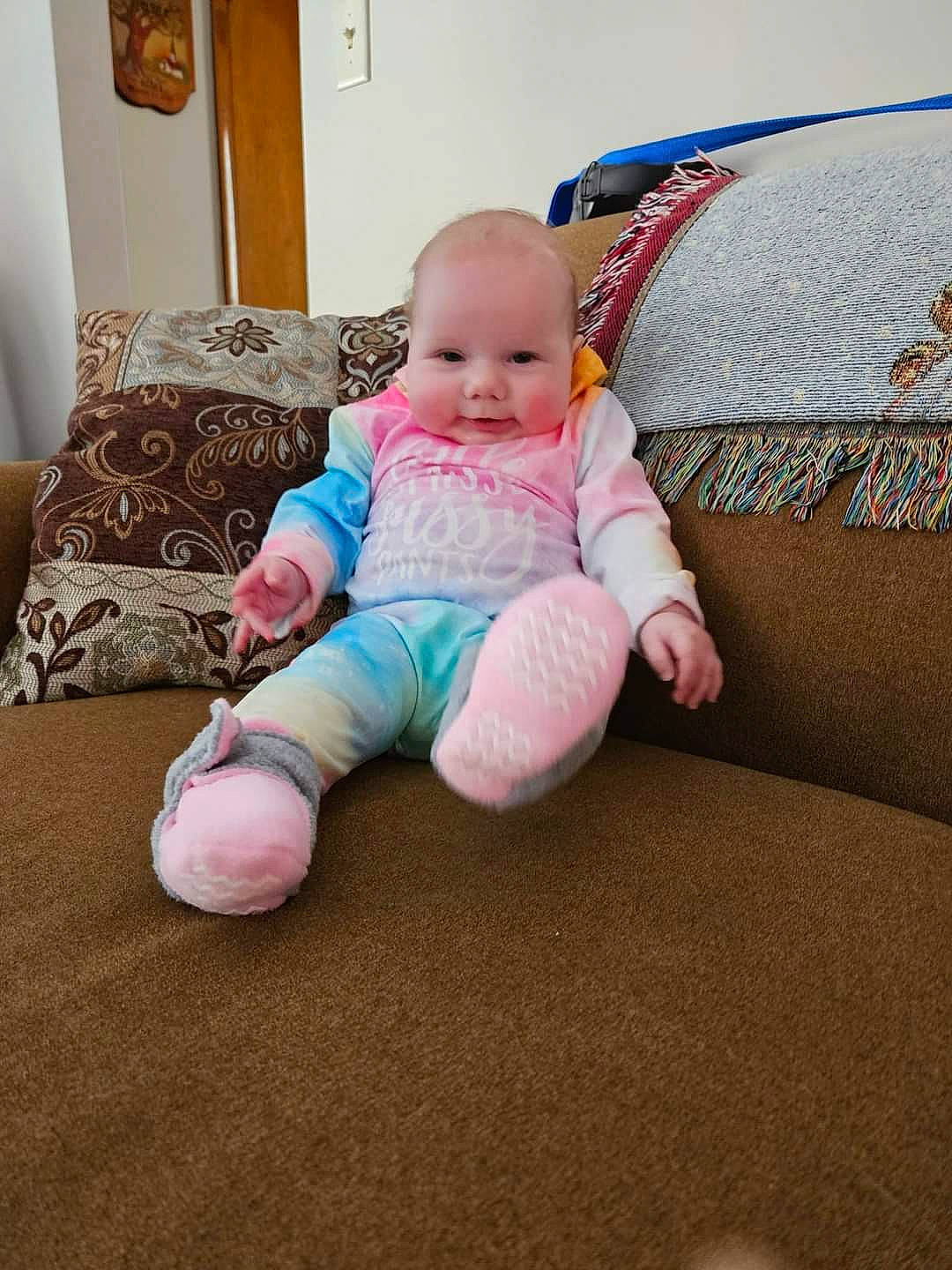 Blakely joined the competition — help win amazing prizes! baby, baby_toddler_clothing, cheek, child, comfort, couch, eye, flooring, foot, human_leg, knee, linens, living_room, person, room, sitting, sleeve, sock, t_shirt, toddler