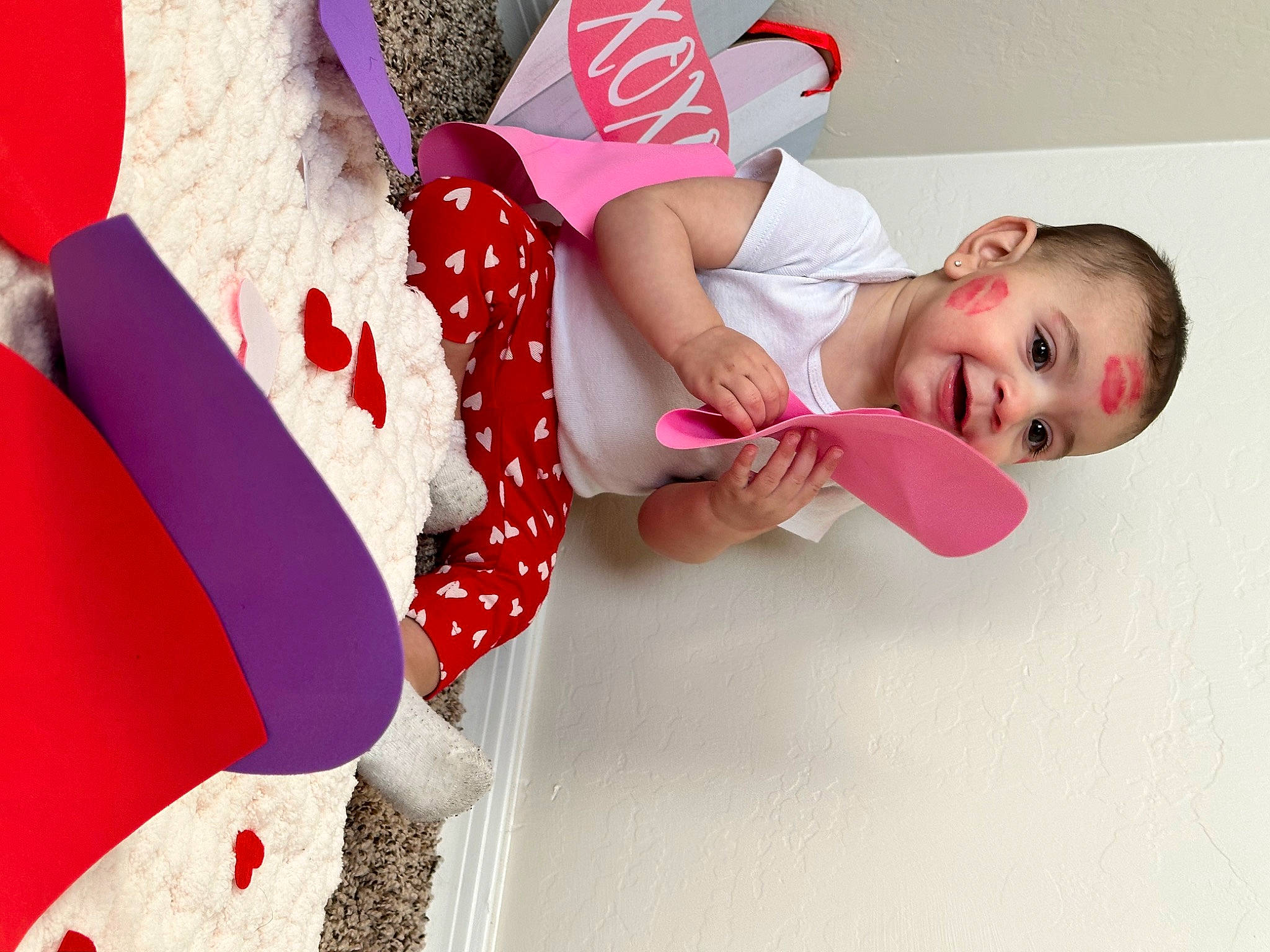 Lina is registered to the contest to win money with this photo: baby, baby_products, baby_toddler_clothing, carmine, child, comfort, dress, happy, hat, human_leg, magenta, pattern, person, pink, red, room, sleeve, smile, sock, thigh