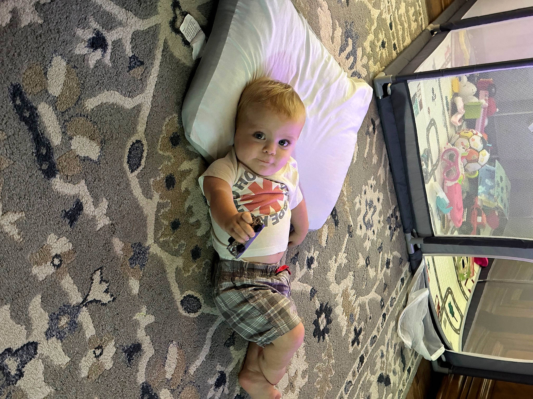 Nash is registered to the contest to win money with this photo: baby, baby_toddler_clothing, child, design, flooring, fun, leisure, linens, magenta, pattern, person, play, product, room, sitting, skin, space, toddler, vacation, visual_arts