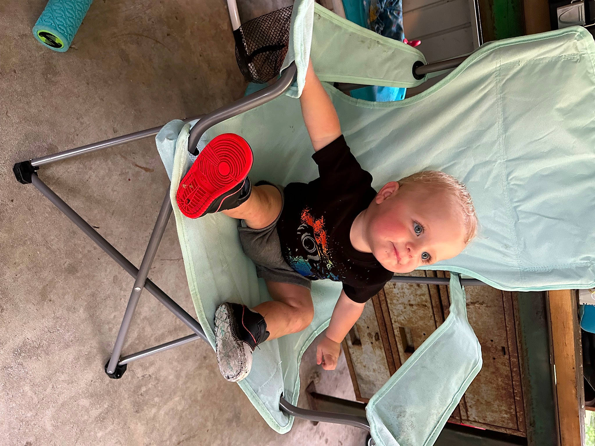 Nash is registered to the contest to win money with this photo: baby, baby_products, baby_toddler_clothing, chair, child, comfort, flooring, folding_chair, fun, hat, human_leg, knee, leisure, person, recreation, sandal, shorts, sitting, t_shirt, toddler