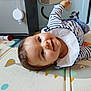 Albane a rejoint le concours — aidez-le/la à gagner de superbes lots ! baby, child, smiling, striped_shirt, play_mat, toy, indoor, happy, face, person, head, crawling, infant, playpen, colorful, cute, young_child, closeup, cheerful, toddler