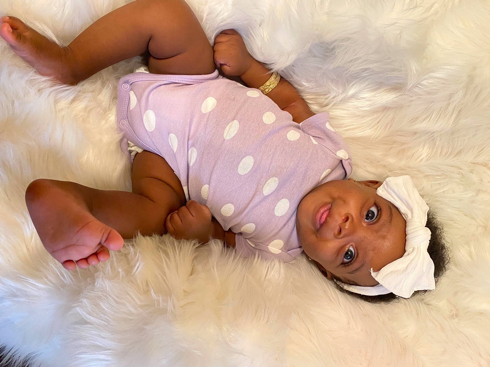 Kaiah is registered to the contest to win money with this photo: baby, baby_sleeping, baby_toddler_clothing, barefoot, bed_sheet, bedding, bedtime, child, comfort, foot, fur, gesture, happy, head, headwear, human_leg, linens, person, pink, room