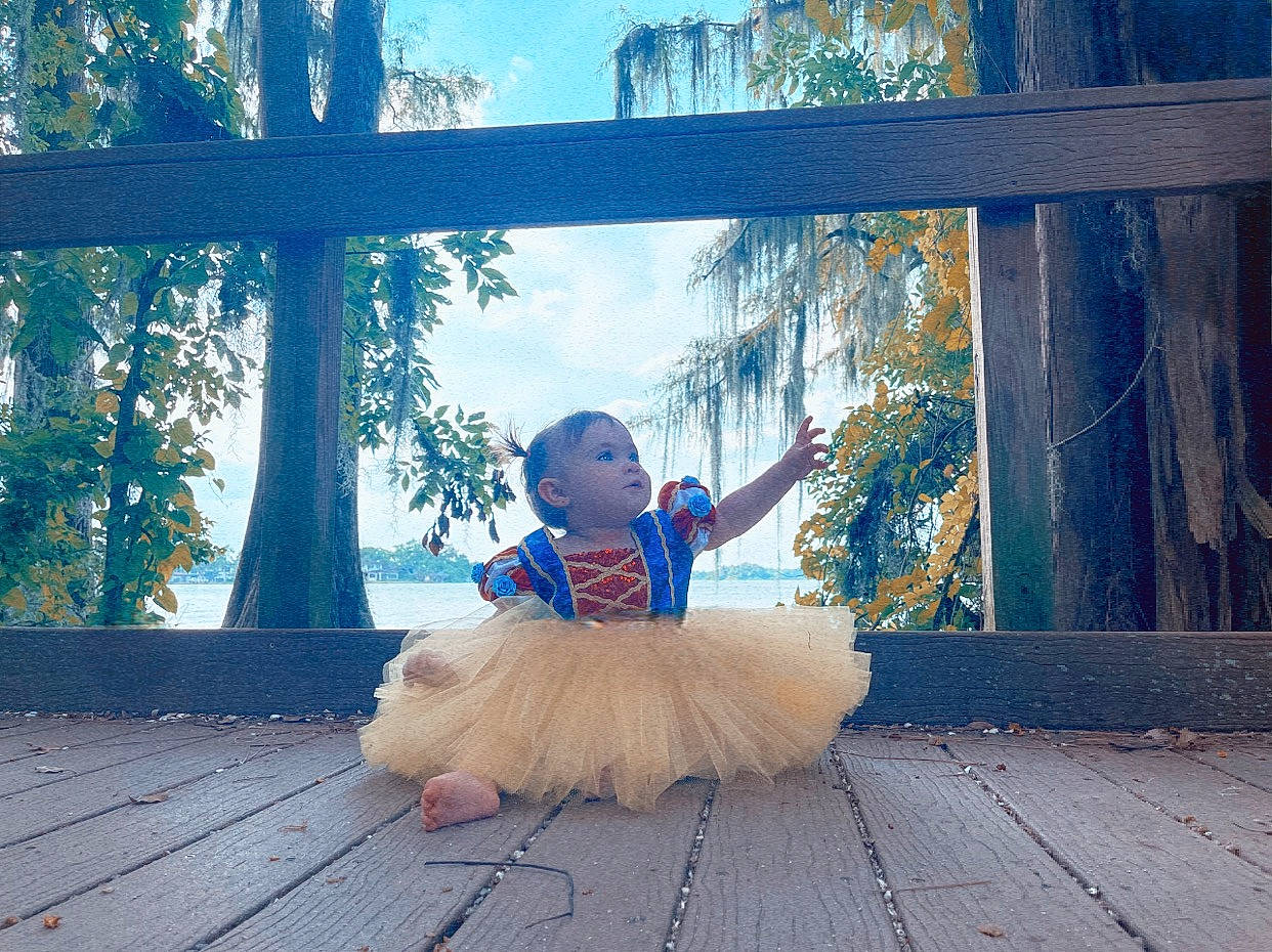 Audree is registered to the contest to win money with this photo: azure, blue, fawn, flooring, hair, happy, hardwood, hat, leg, leisure, morning, nature, people_in_nature, person, plant, sky, sunlight, tints_and_shades, toddler, tree