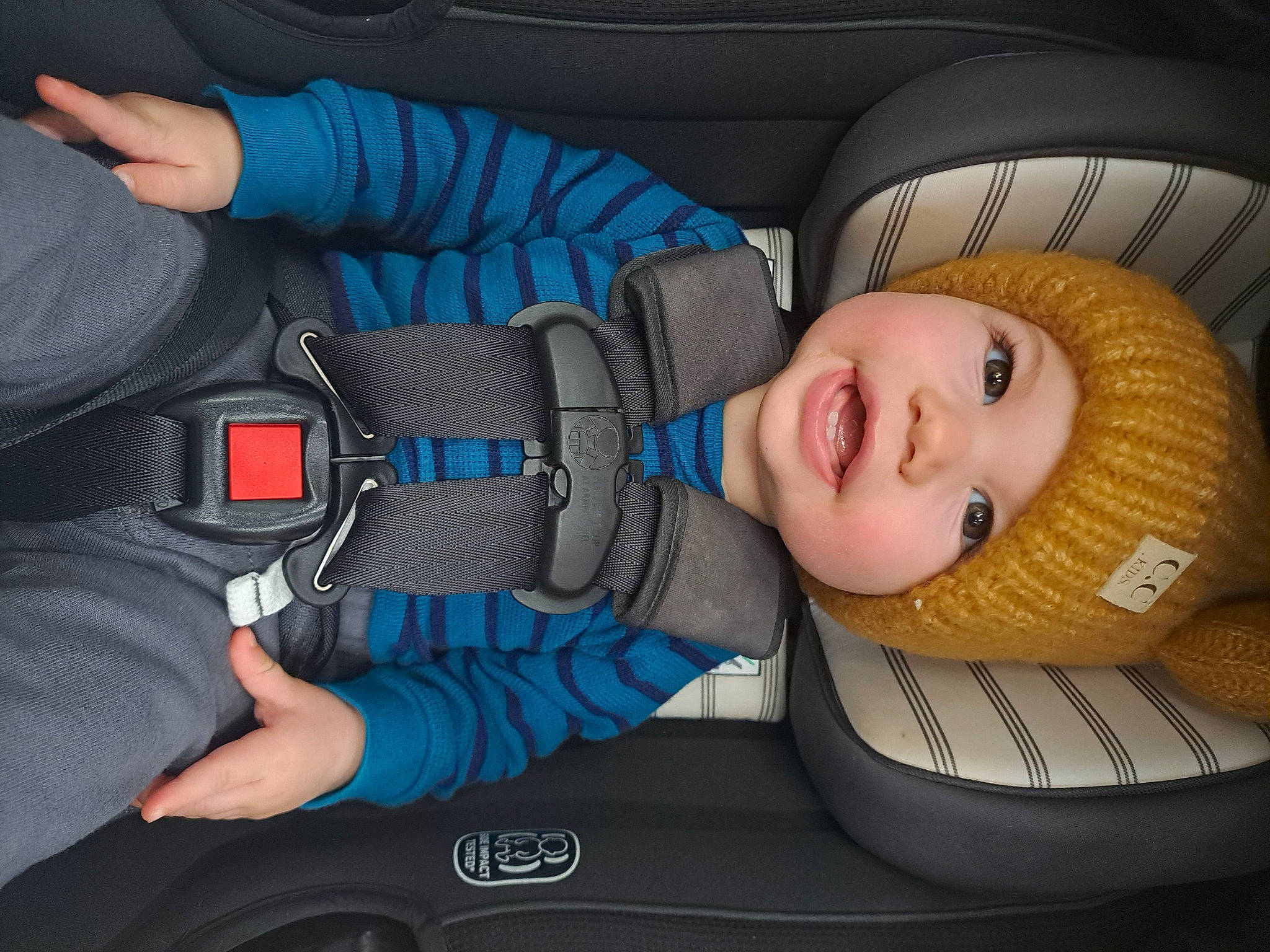 Edison is registered to the contest to win money with this photo: auto_part, automotive_design, automotive_exterior, automotive_wheel_system, baby_carriage, baby_in_car_seat, car, car_seat, car_seat_cover, comfort, cool, head_restraint, headwear, motor_vehicle, person, product, seat_belt, smile, steering_wheel, toddler